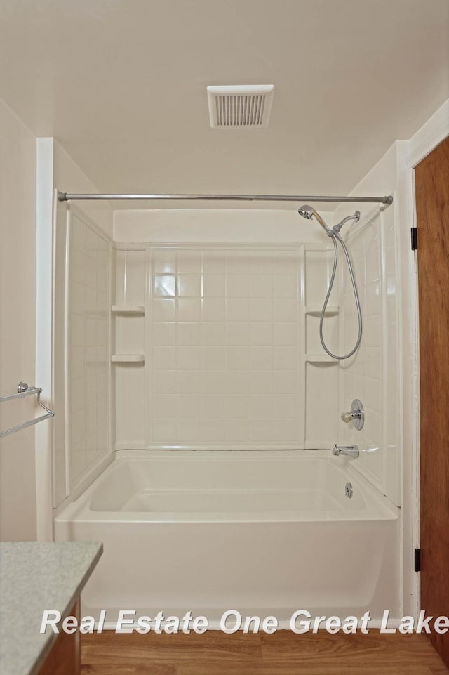 bathroom with shower / bathing tub combination and vanity