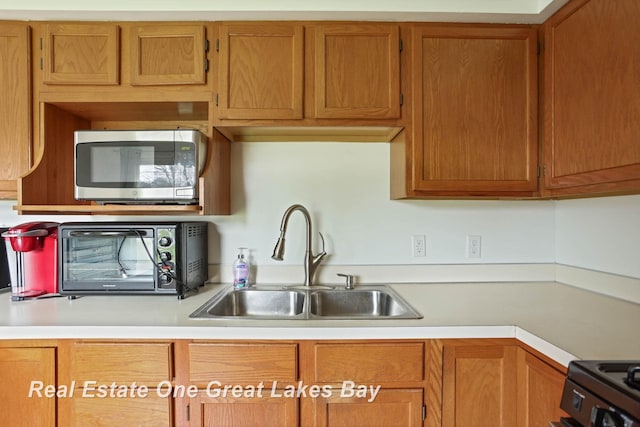 kitchen with sink and electric range