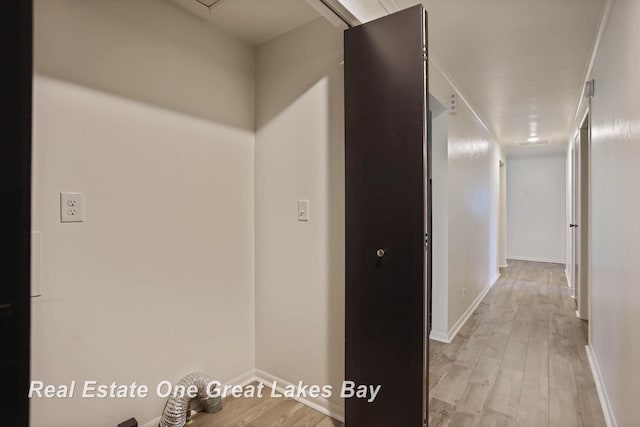 hallway with light hardwood / wood-style floors