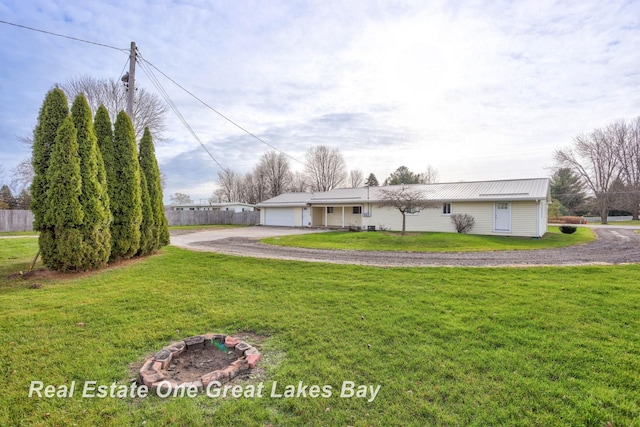 single story home with a front yard and a garage