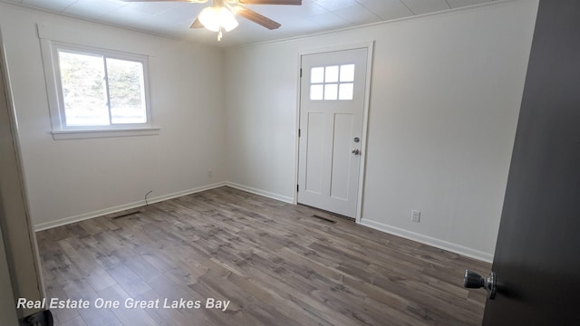 foyer entrance featuring hardwood / wood-style floors, ornamental molding, and ceiling fan