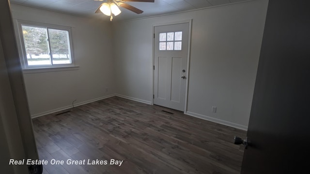 entrance foyer featuring ceiling fan, dark hardwood / wood-style flooring, and ornamental molding