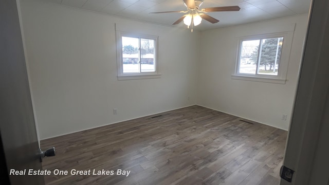 unfurnished room with ceiling fan and hardwood / wood-style floors