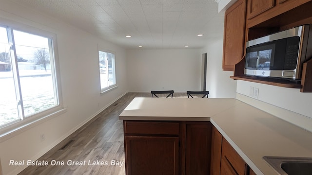 kitchen featuring light wood-type flooring and kitchen peninsula