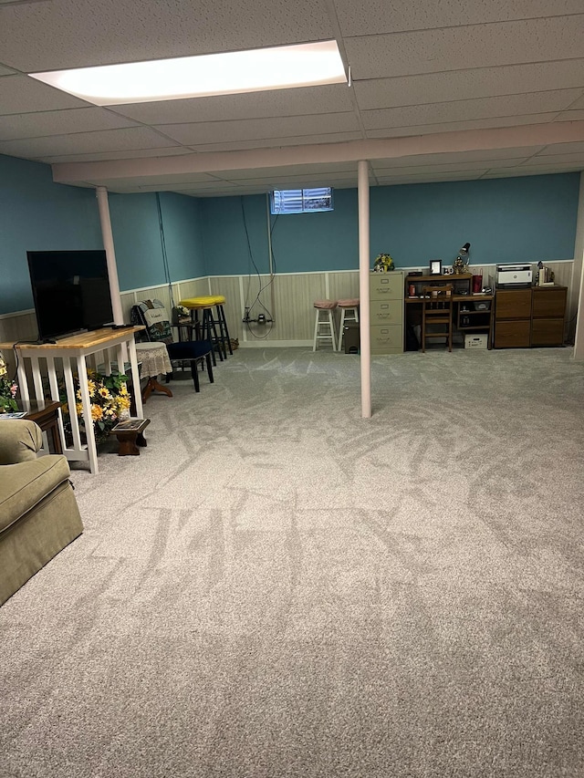 basement with a drop ceiling and carpet floors