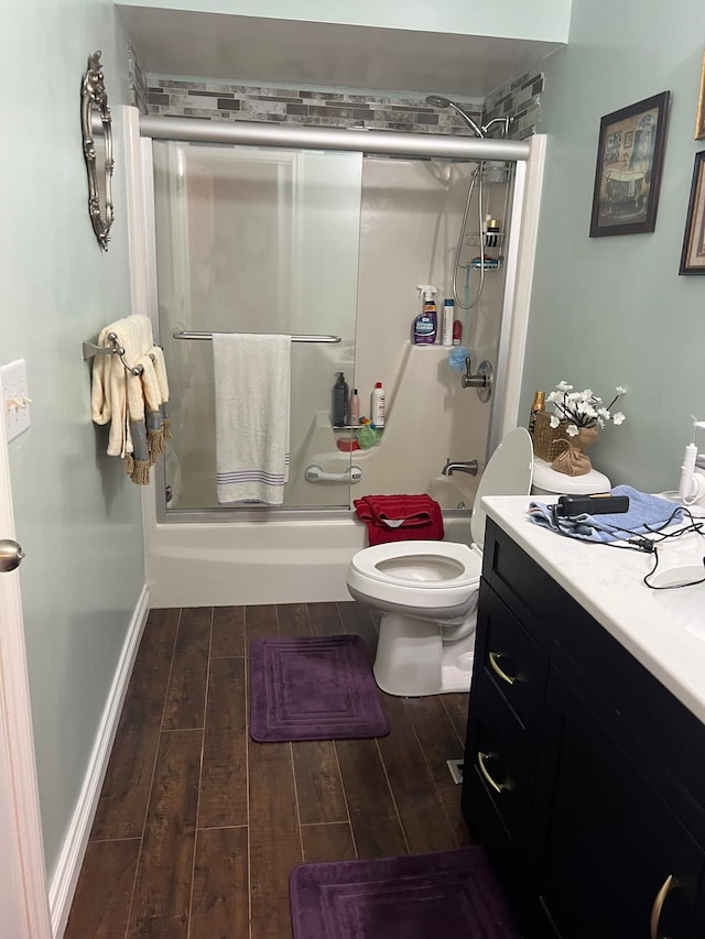 full bathroom featuring shower / bath combination with glass door, wood-type flooring, vanity, and toilet