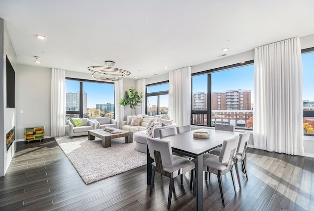 dining room featuring plenty of natural light, dark hardwood / wood-style flooring, and an inviting chandelier