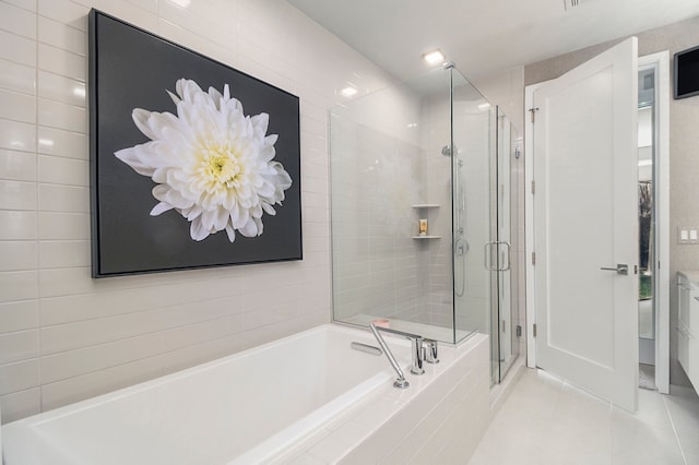 bathroom featuring tile patterned flooring and independent shower and bath