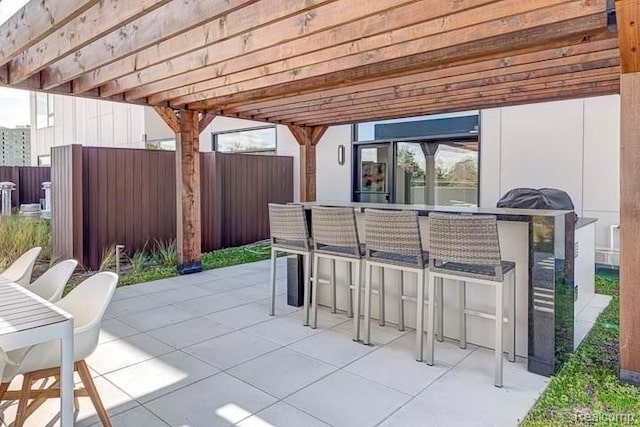 view of patio with a bar and a pergola