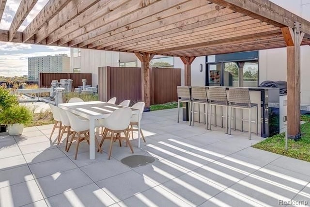 view of patio / terrace featuring a bar and a pergola