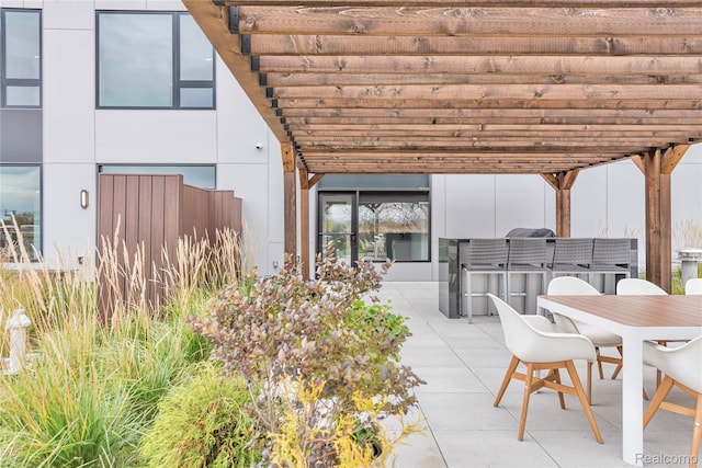 view of patio with a pergola and an outdoor kitchen