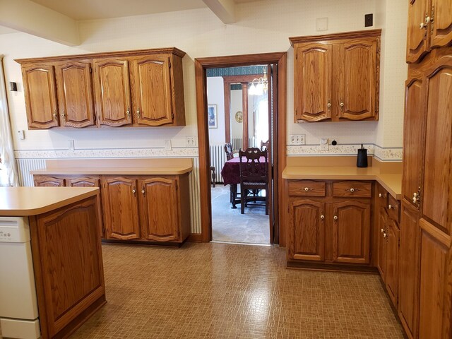 kitchen with white dishwasher, radiator, and beam ceiling