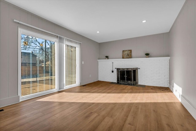 unfurnished living room featuring light hardwood / wood-style floors and a fireplace