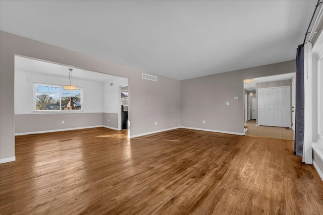 unfurnished living room featuring hardwood / wood-style flooring