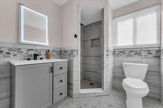 bathroom featuring tile patterned floors, vanity, and tile walls