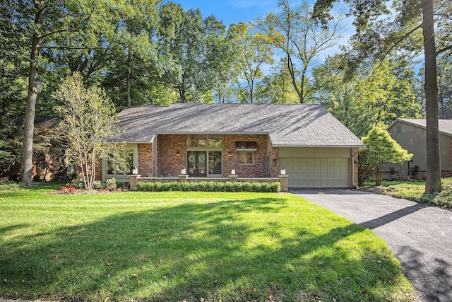 single story home with a garage and a front lawn