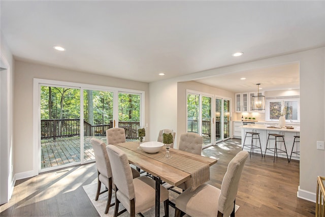 dining space with a chandelier, light hardwood / wood-style floors, and a healthy amount of sunlight