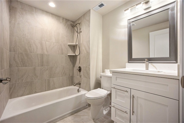 full bathroom featuring vanity, toilet, and tiled shower / bath