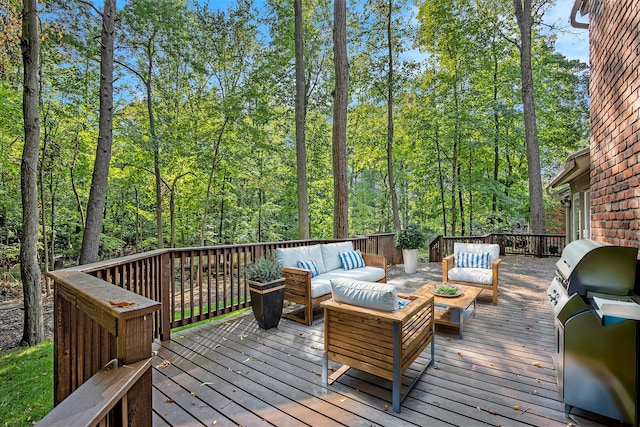 wooden terrace with an outdoor living space and grilling area