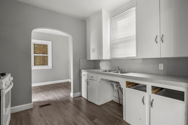 kitchen with sink, white cabinets, and white gas range oven