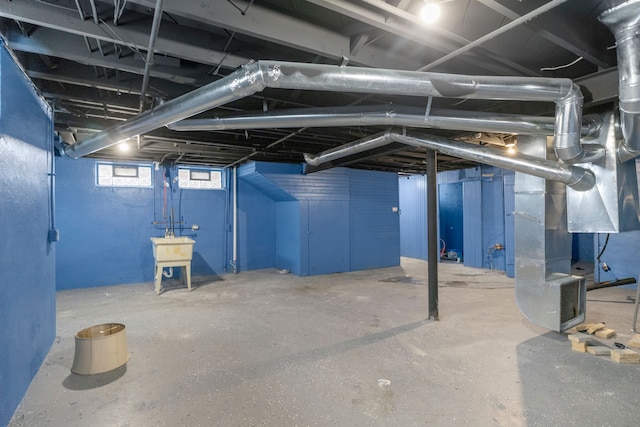 basement with heating unit and sink