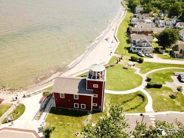 birds eye view of property with a beach view and a water view