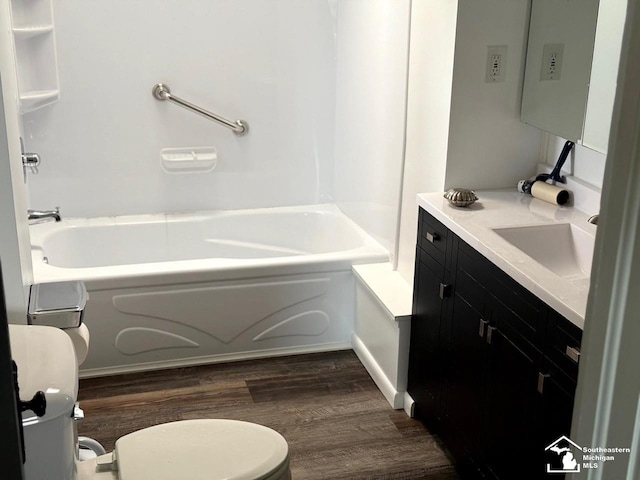 full bathroom with wood finished floors, toilet, tub / shower combination, and vanity