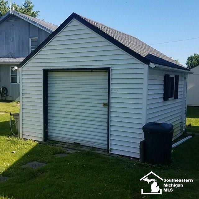 view of outbuilding with a yard