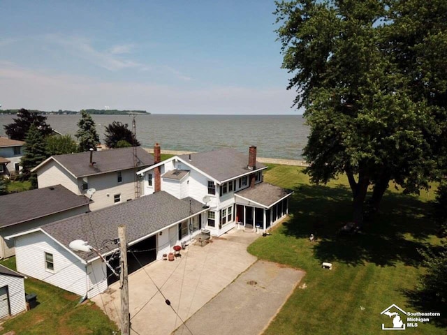 birds eye view of property with a water view