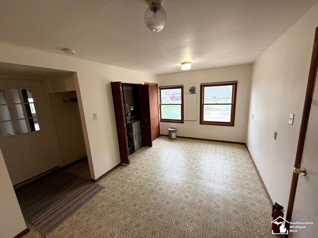empty room with light floors and baseboards
