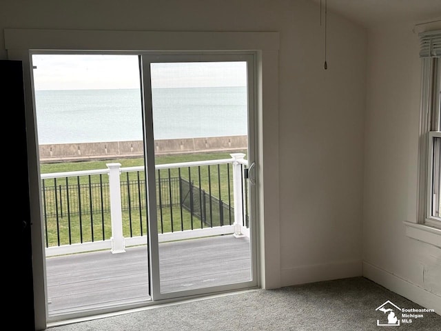 doorway featuring carpet flooring and a water view