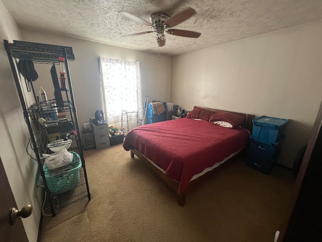 bedroom featuring carpet flooring, a textured ceiling, and ceiling fan