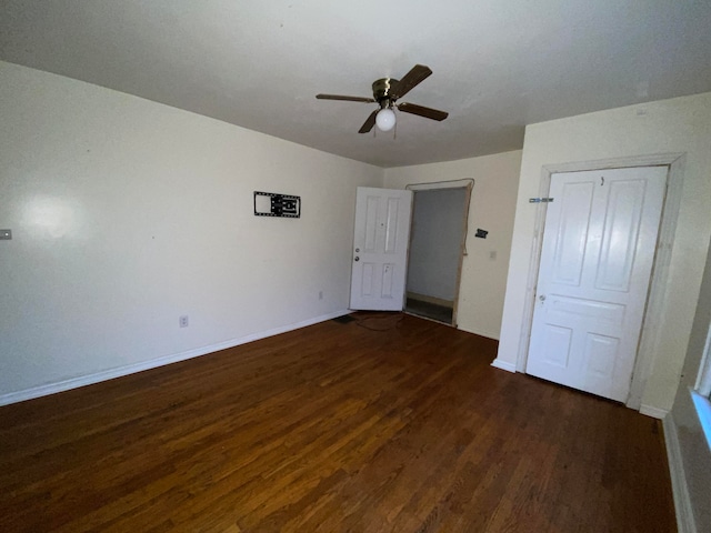 unfurnished bedroom featuring ceiling fan and dark wood-type flooring