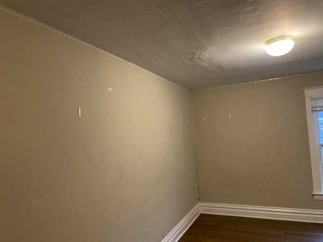 unfurnished room featuring a textured ceiling and hardwood / wood-style floors