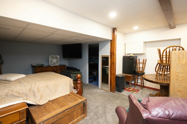 carpeted bedroom with a paneled ceiling