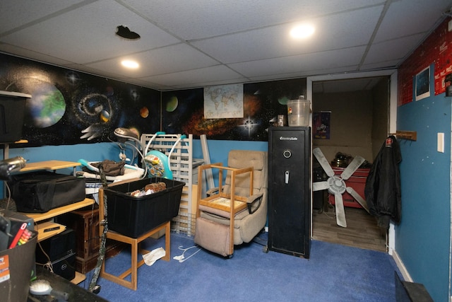 interior space with a paneled ceiling and carpet floors