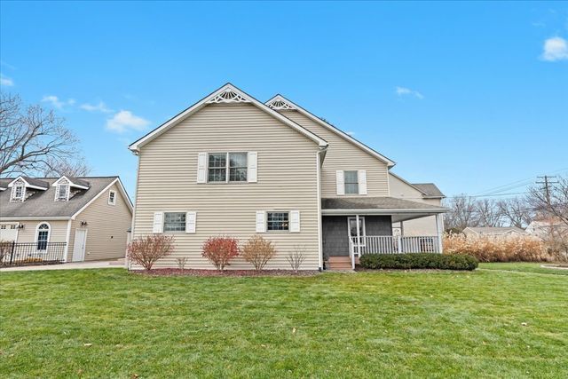 rear view of property with a lawn