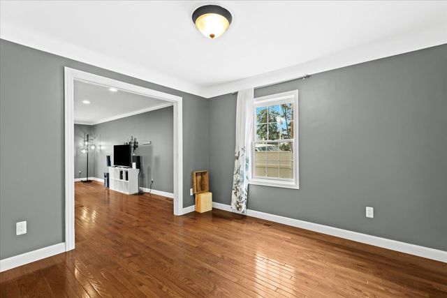 1807 Samoset Rd, Royal Oak, MI 48073 - spare room with baseboards, ornamental molding, and wood finished floors