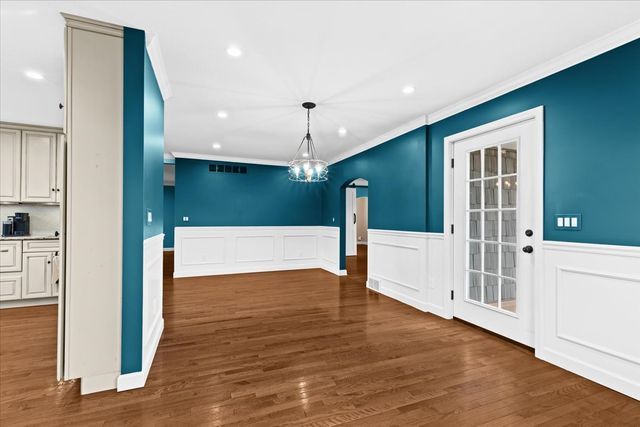 1807 Samoset Rd, Royal Oak, MI 48073 - unfurnished dining area featuring crown molding, an inviting chandelier, wainscoting, and recessed lighting