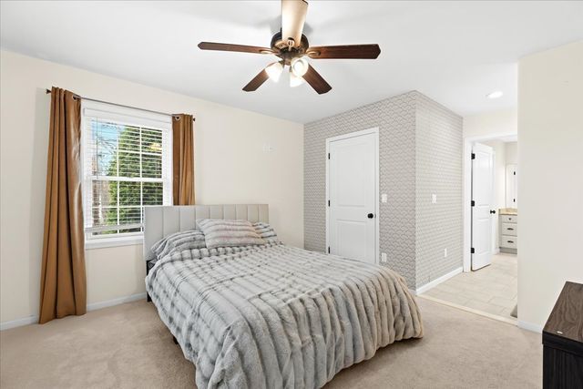 bedroom featuring ceiling fan and light colored carpet