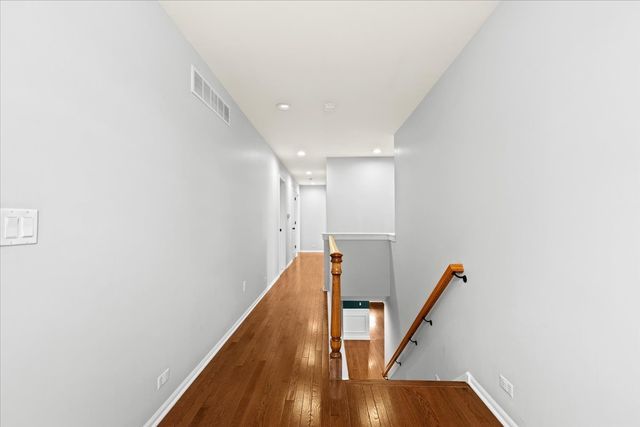 hall featuring wood-type flooring and a wall mounted AC