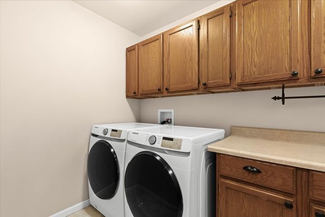 1807 Samoset Rd, Royal Oak, MI 48073 - washroom with separate washer and dryer, cabinet space, and baseboards