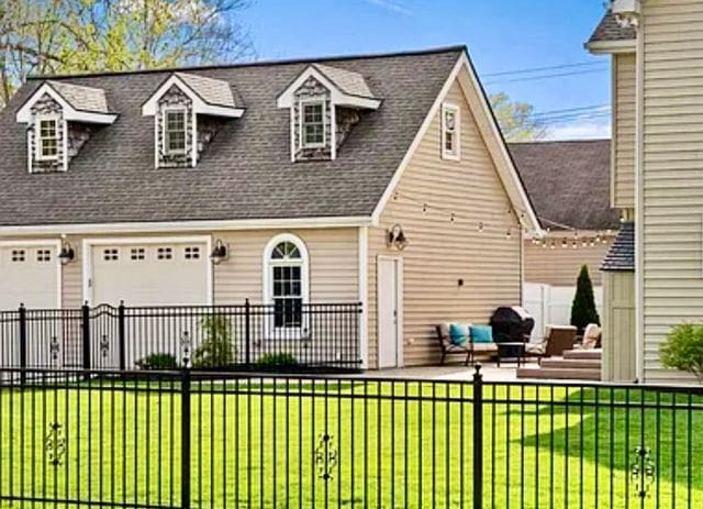 view of front of house with a patio area and a front yard