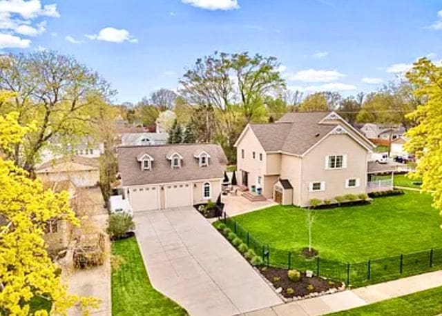 1807 Samoset Rd, Royal Oak, MI 48073 - view of front facade featuring an attached garage, fence, a front yard, and concrete driveway