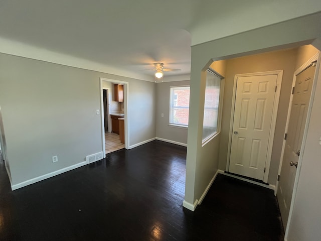 interior space featuring ceiling fan and dark wood-type flooring