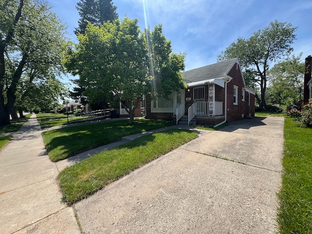 bungalow-style home with a front lawn