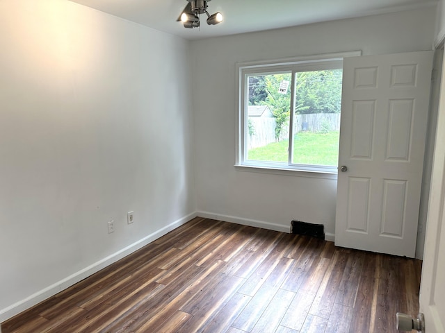 spare room with dark hardwood / wood-style flooring and ceiling fan