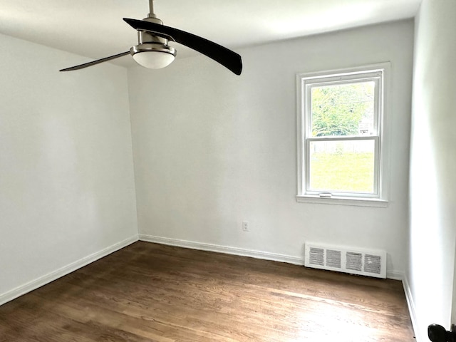 unfurnished room with ceiling fan and dark wood-type flooring