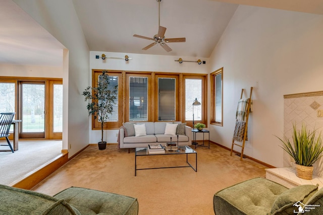 carpeted living room featuring high vaulted ceiling, a wealth of natural light, and ceiling fan