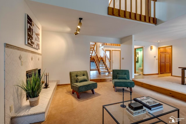 carpeted living room with a tile fireplace